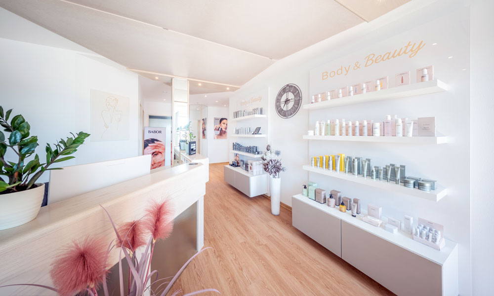 Empfangsbereich von BODY & Beauty mit BABOR Pflegeprodukten im Regal